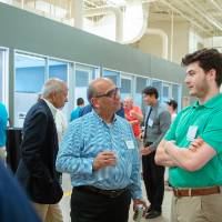 Two guests chatting at the Engineering Design Project Preview
